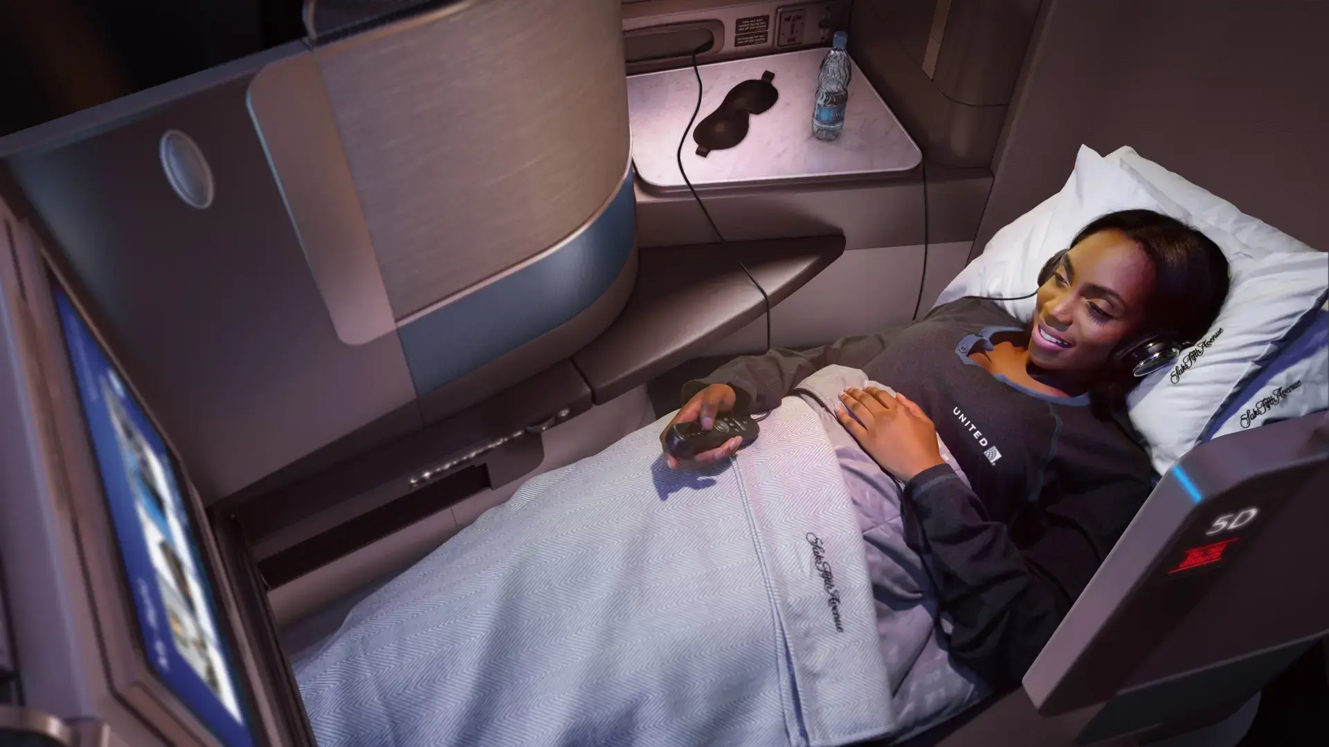 A woman watching tv on her businessclass seat