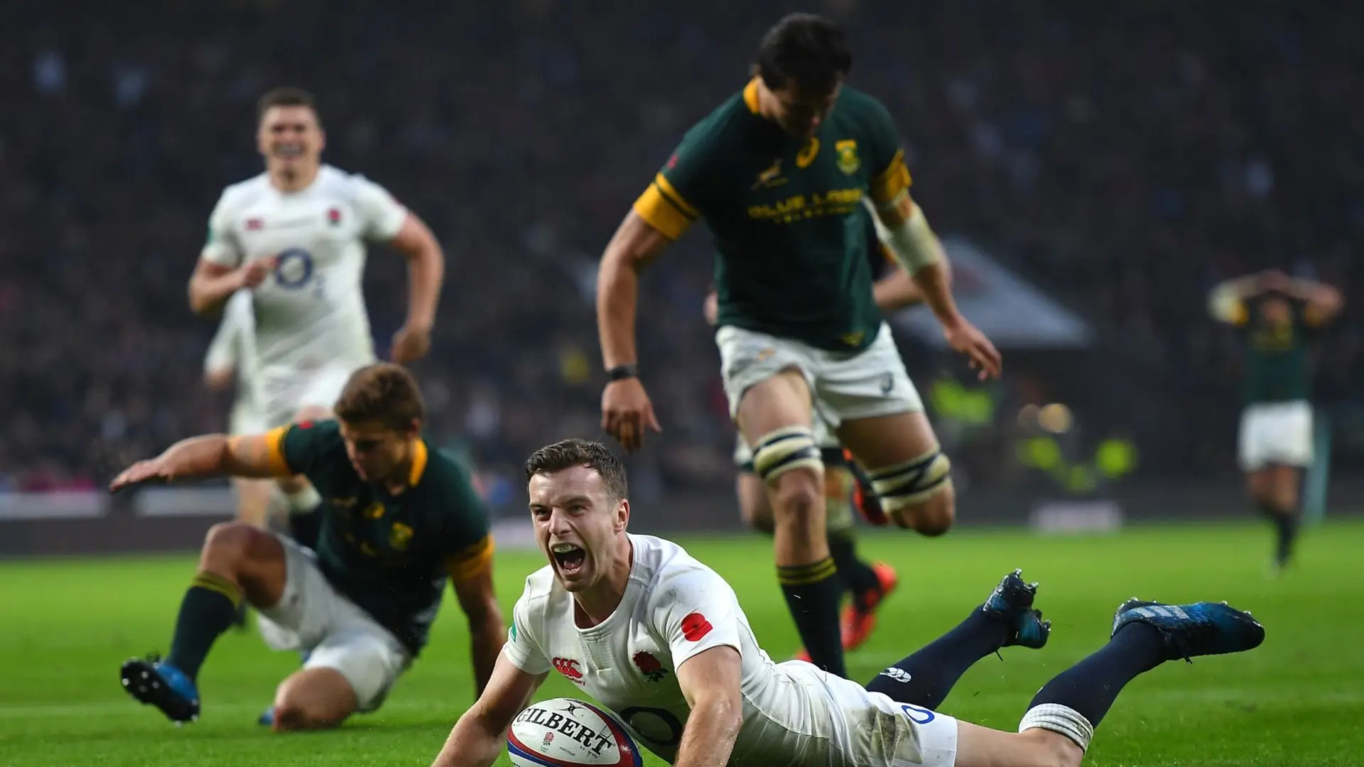 players sliding in the grass at Twickenham 
