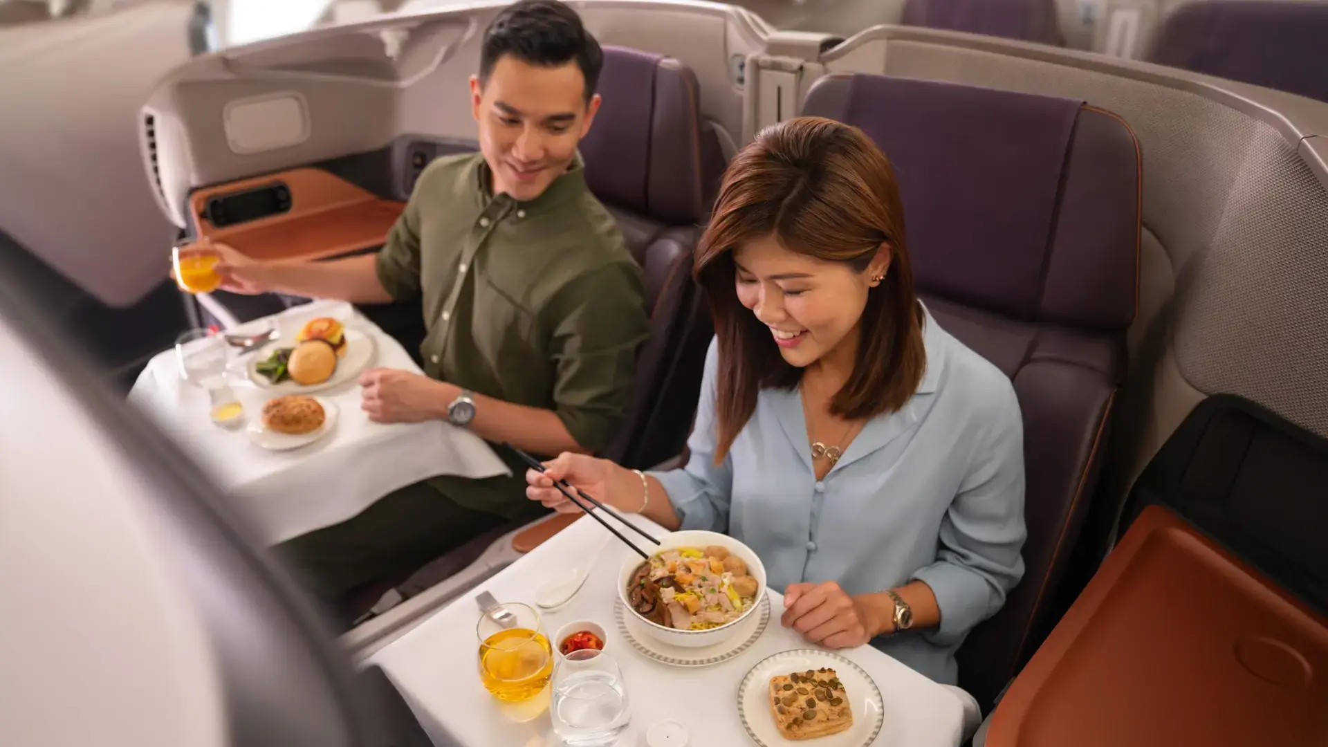 a couple enjoying their business class meal