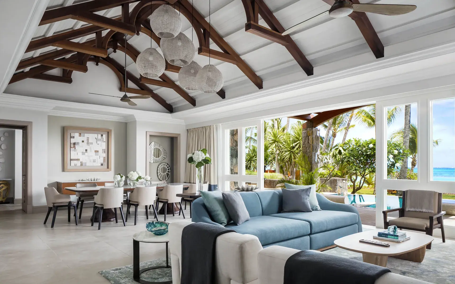 lounge and dinning area of a room at One&Only Le Saint Geran