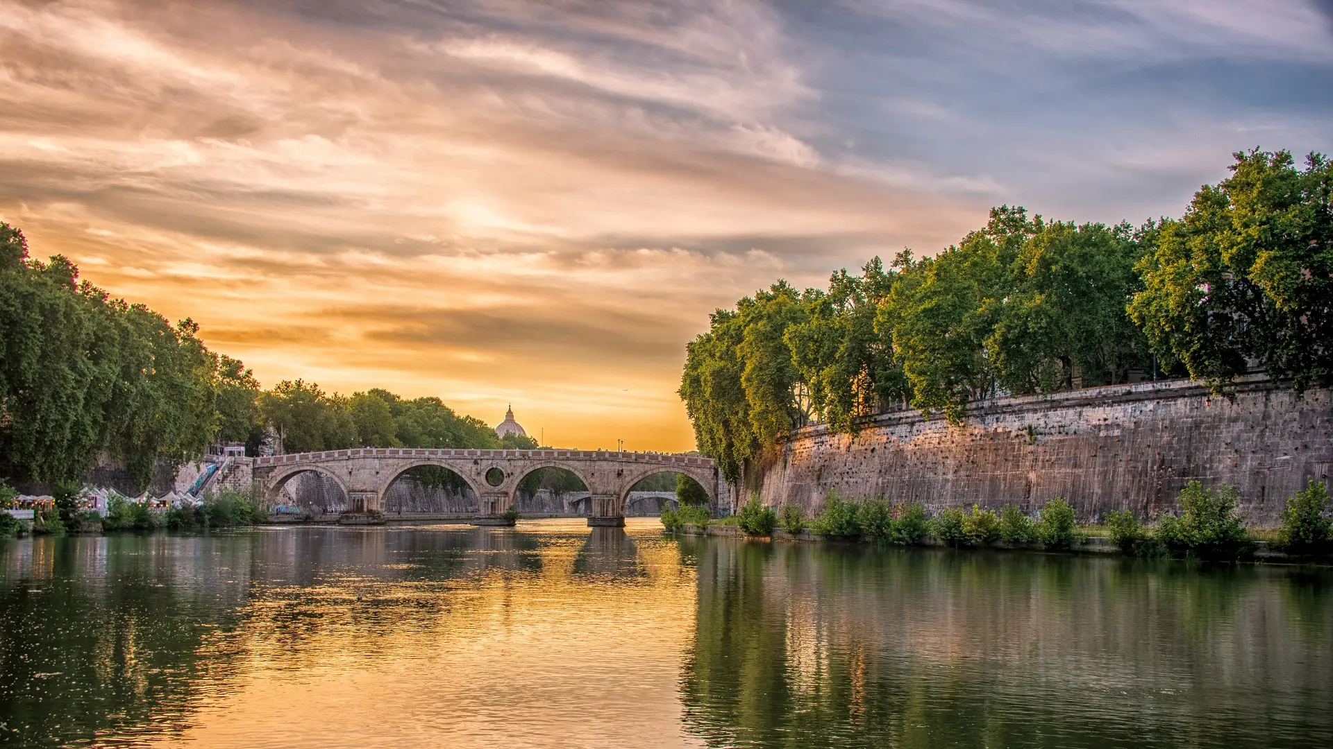 "Image of the Tiber River gently flowing through the heart of Rome, with ancient city buildings lining the banks, lush greenery in the foreground, and a serene yellow sky overhead, reflecting the tranquil mood of the scene."