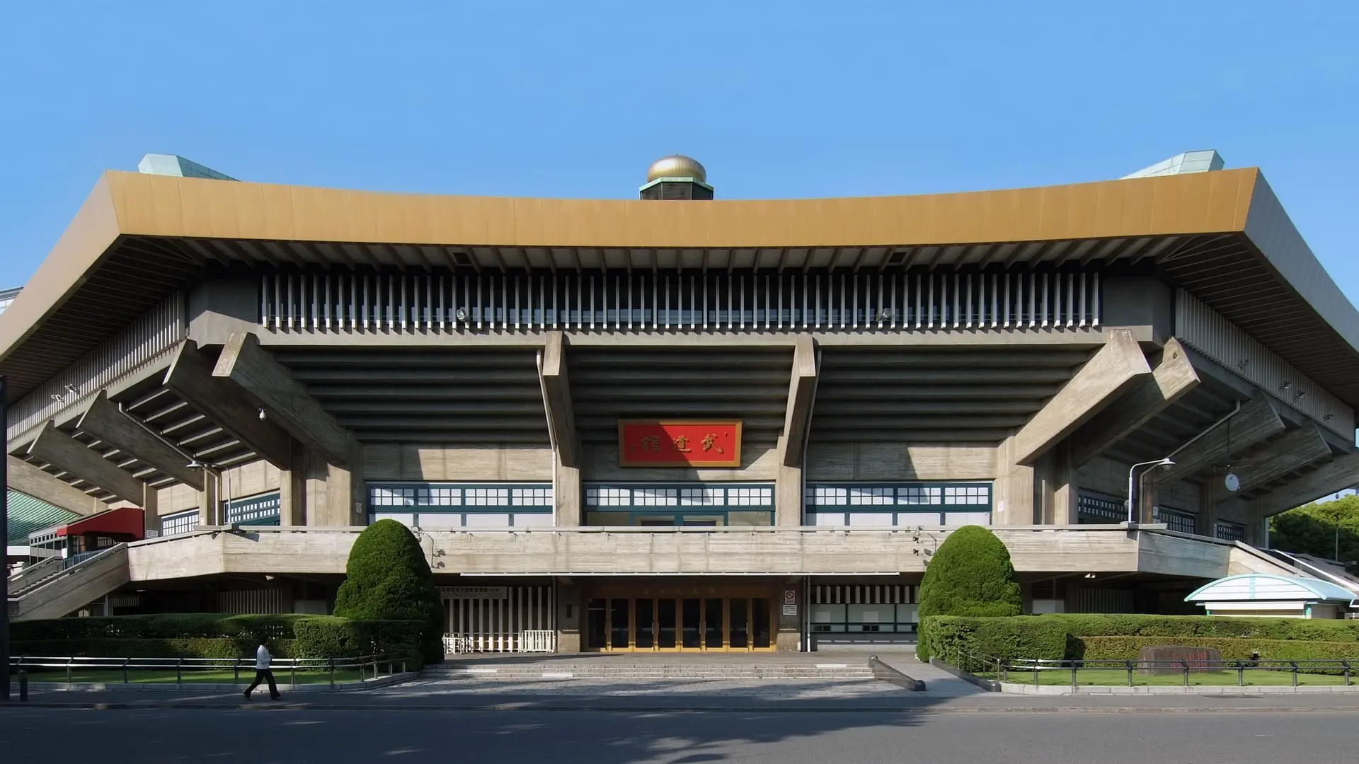 Futuristic temple looking building with red box in chineese The Tokyo Budokan.