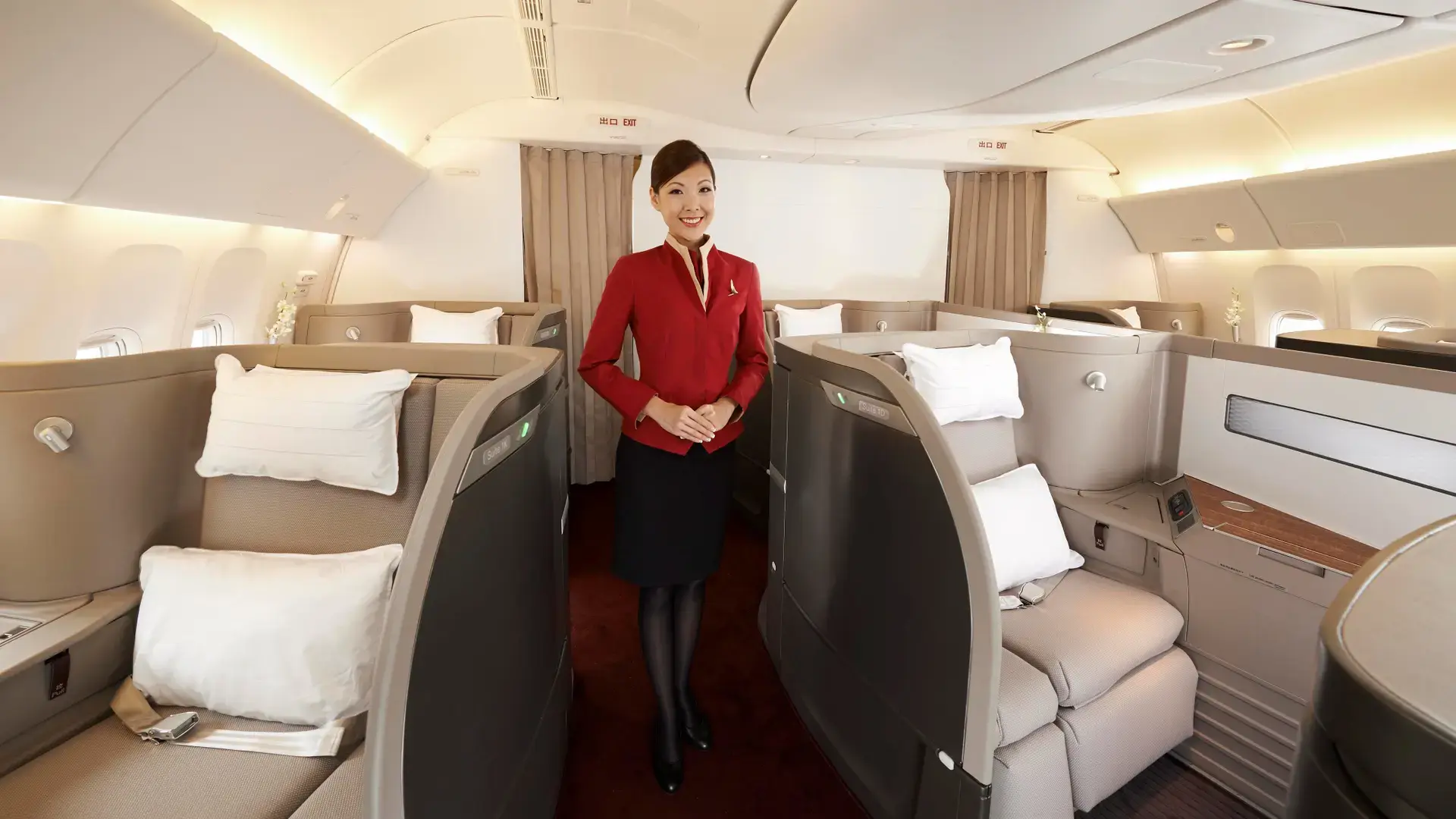 Cathay Pacific air hostess standing in the first class