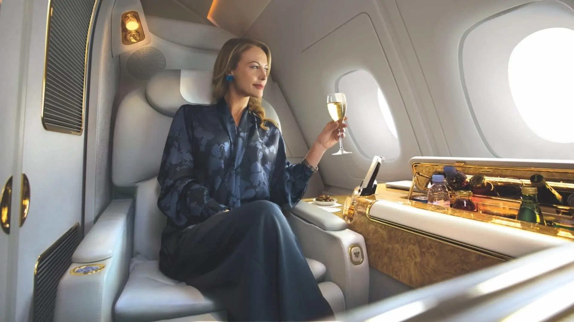woman enjoying Unlimited vintage Champagne and Caviar - Emirates First Class