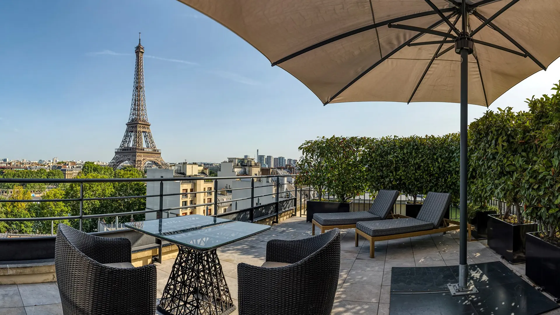 Outside terrace with sunbeds and table at shangri-la hotel paris