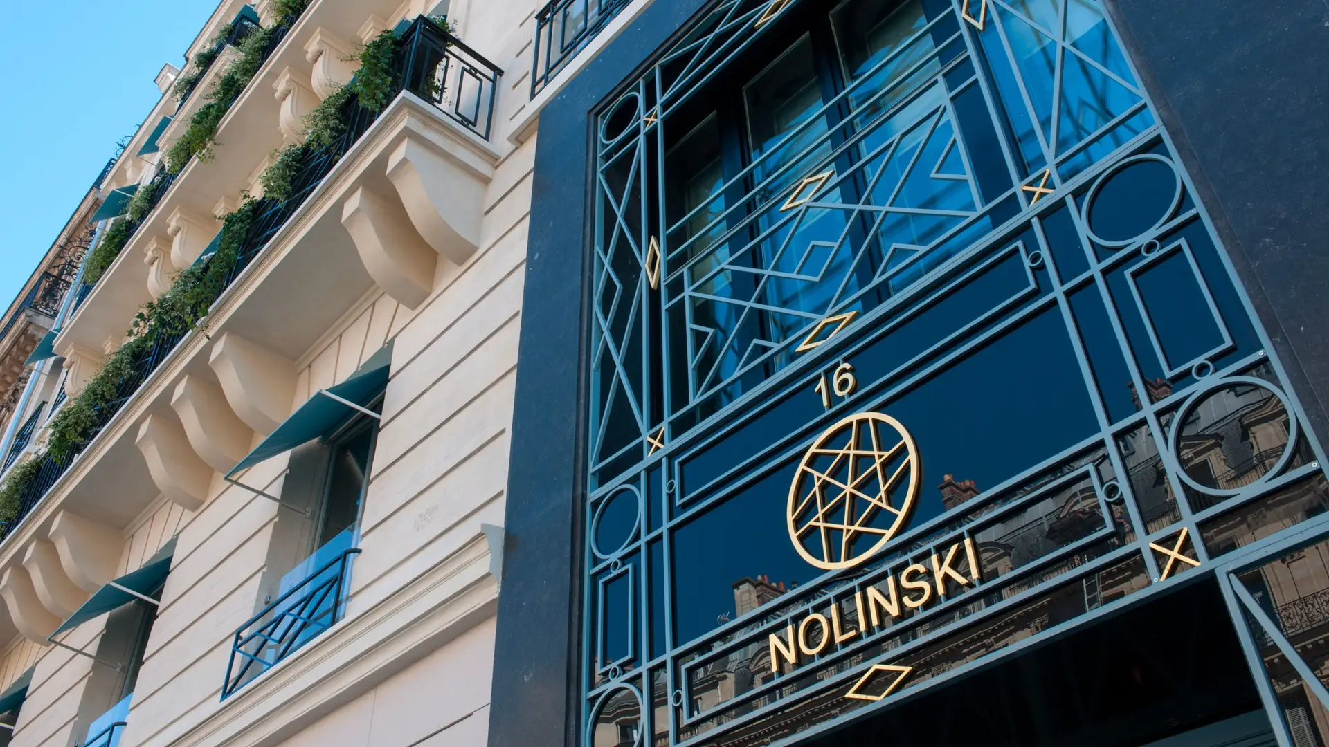 Main entrance of Nolinski hotel paris with the logo in gold.