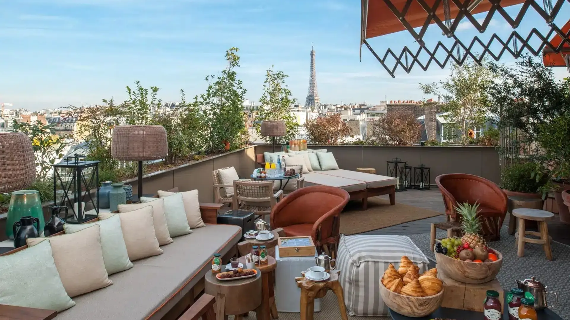 Terrace at hotel brach paris with a sofa, sunbeds, food and drinks