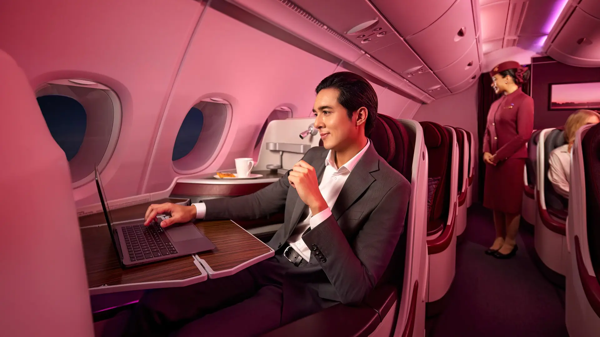 man sitting in the qatar airways business class cabin