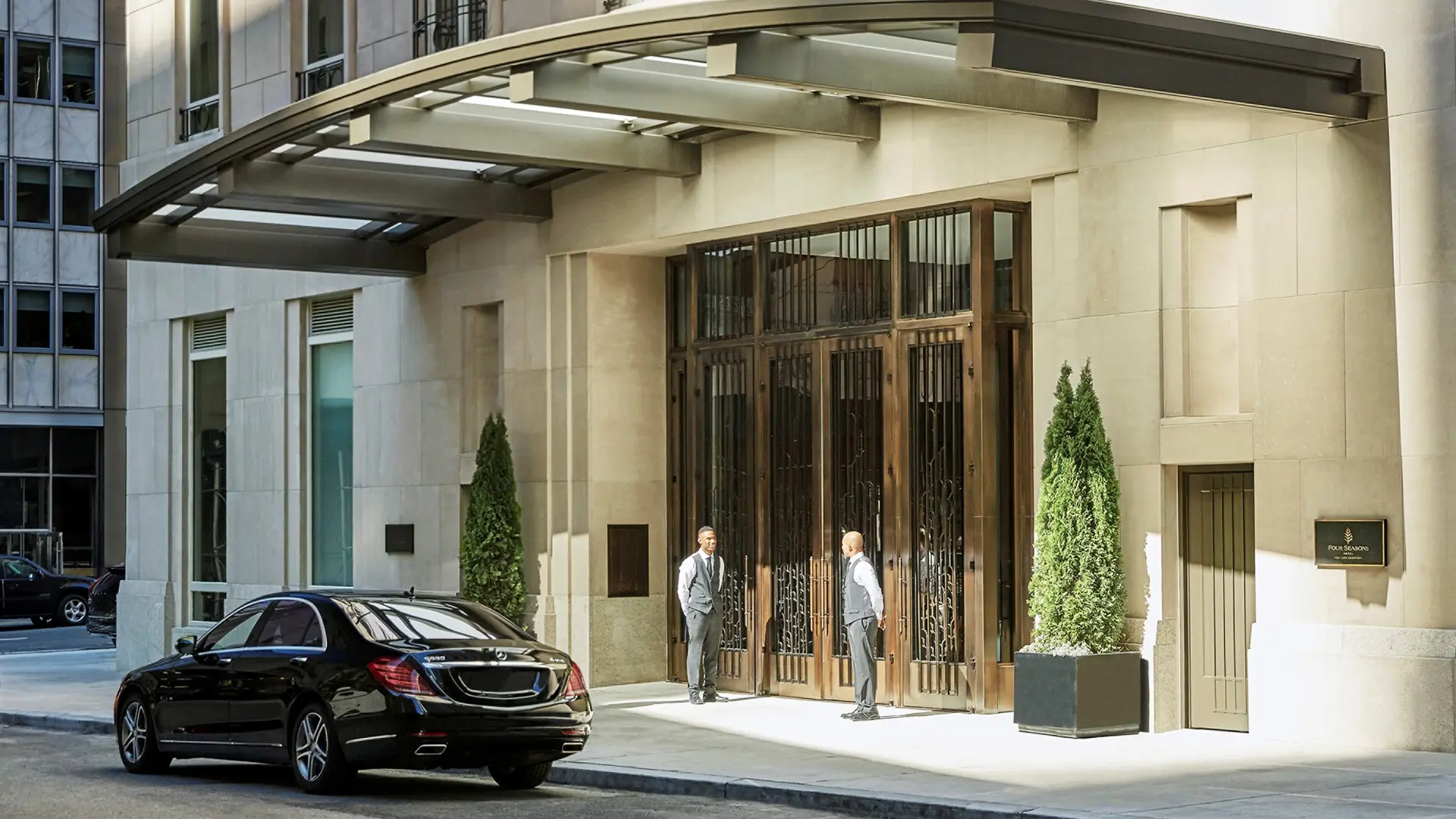 main entrance of Four Seasons Hotel New York Downtown with two doormen standing by the door