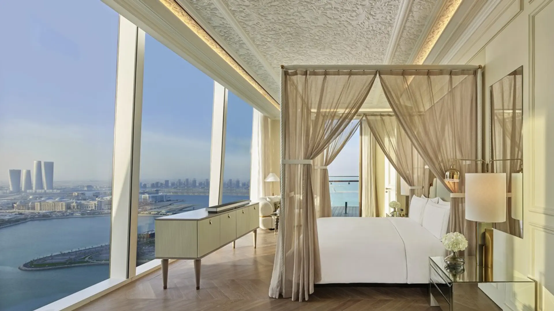 a room at Raffles Doha overlooking the river and city through its large windows