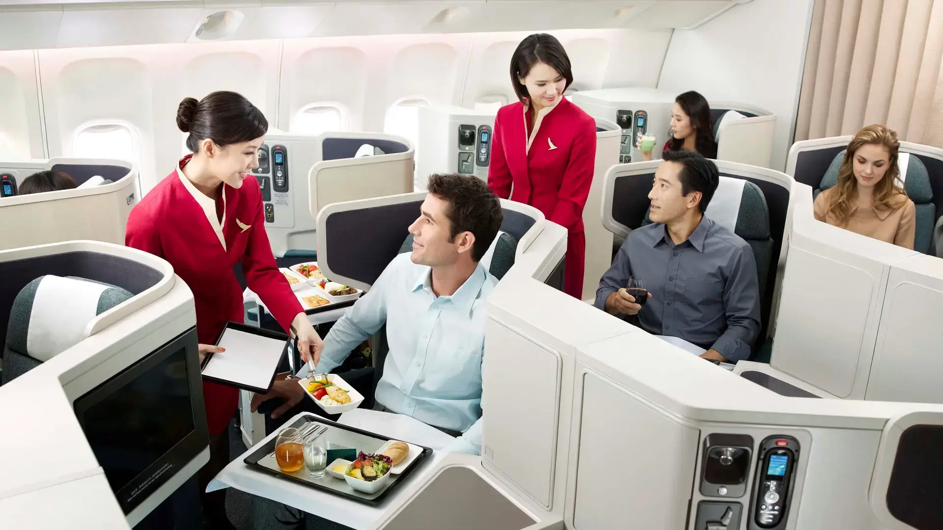 passengers in Cathay Pacific's business class getting food served