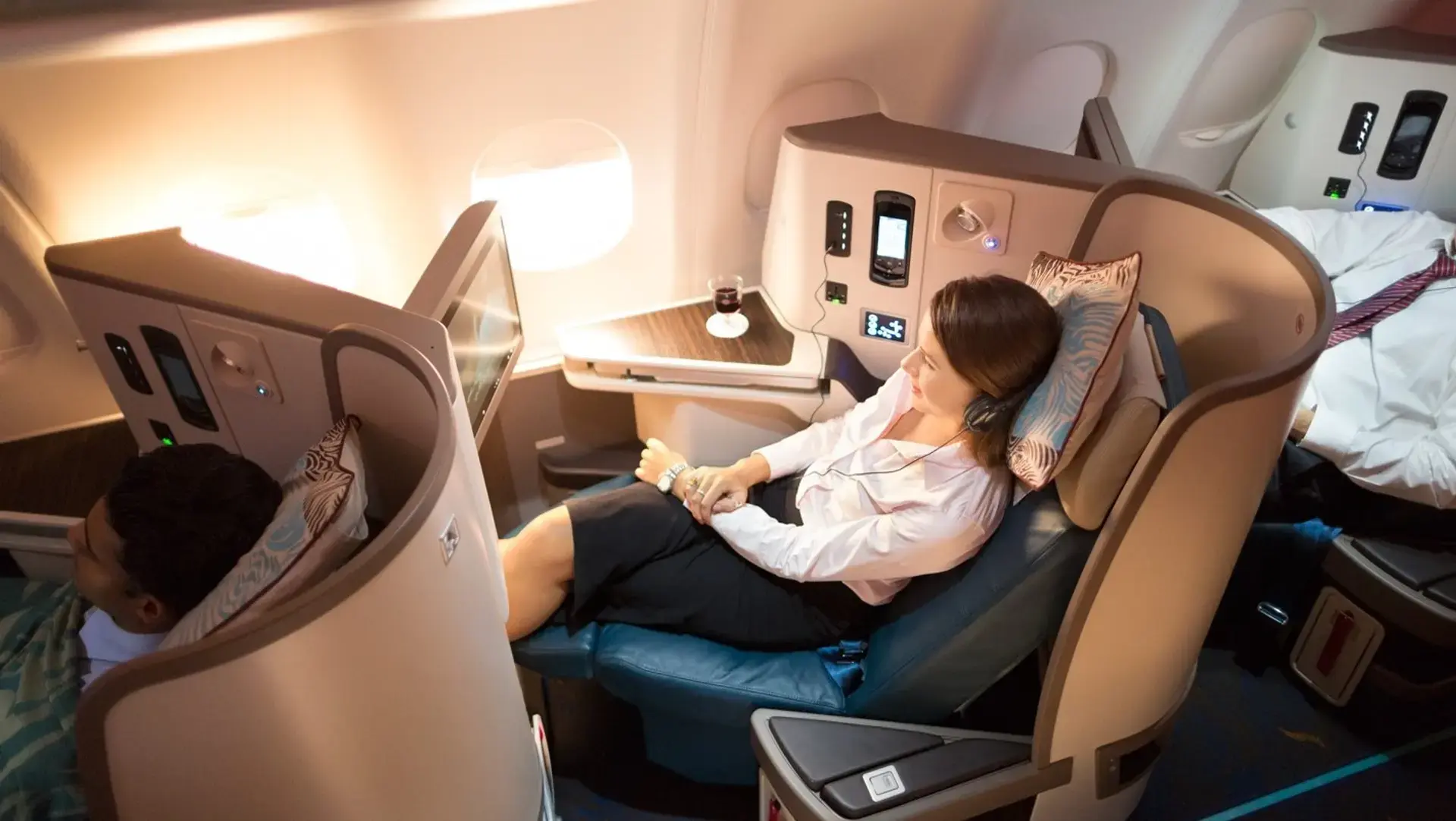 a woman using the inflight entertainment system in SriLankan Airlines business class