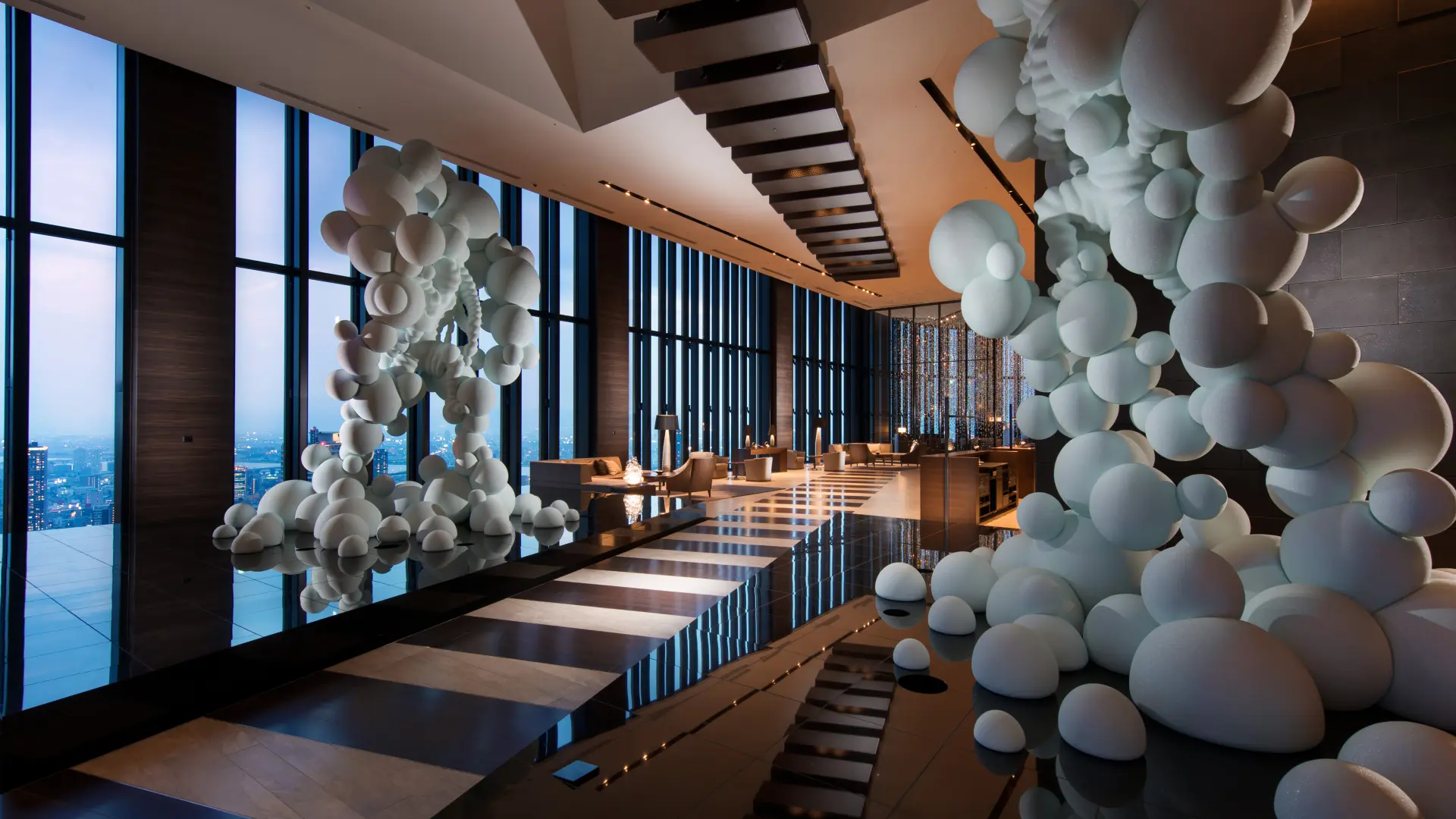 Inside Conrad Osaka, dining area with windows and white sculptures.