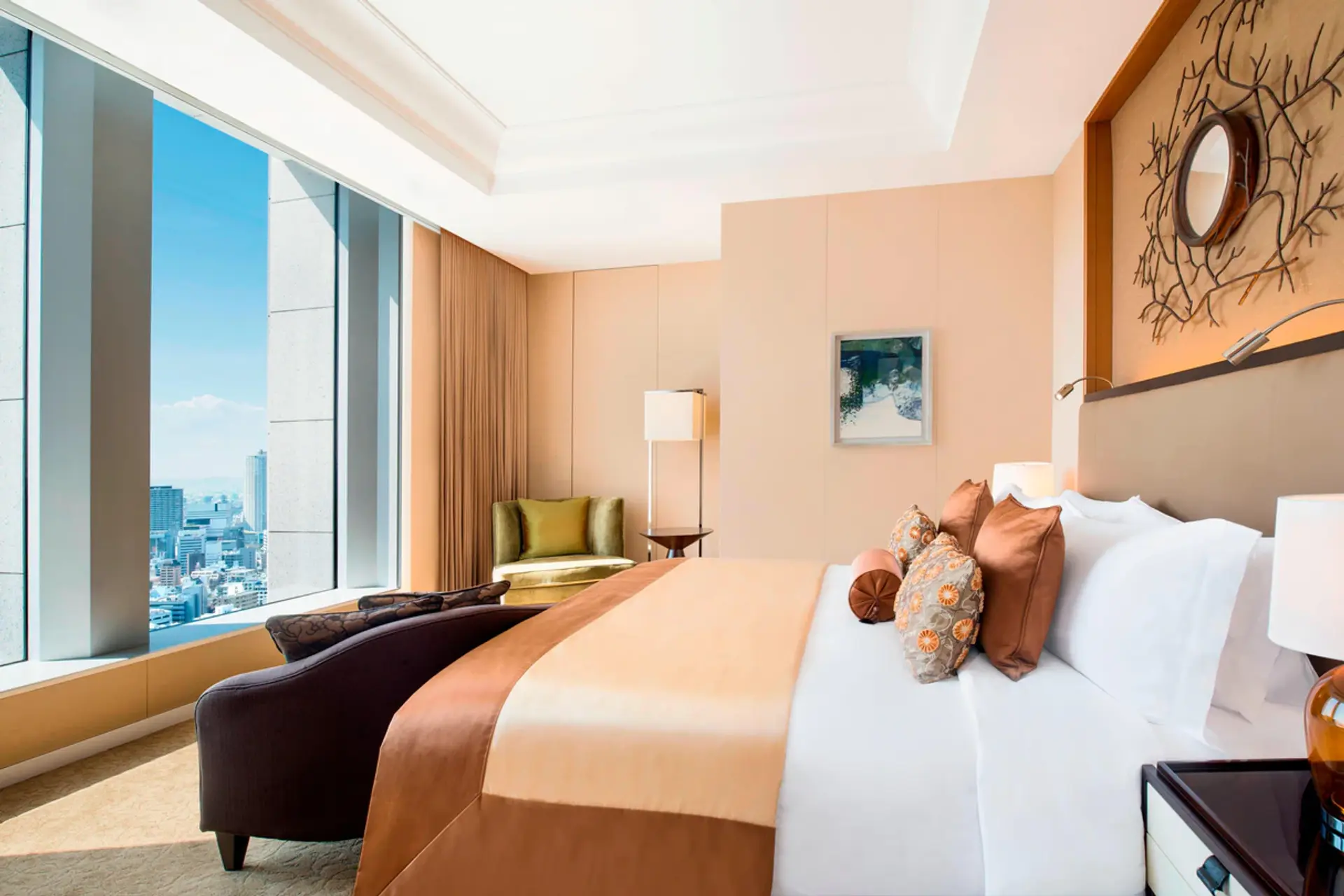 Bedroom with view to the city of Osaka, gold/bronze coloured silk carpet on the kingsize bed and walls. at The St Regis Osaka.