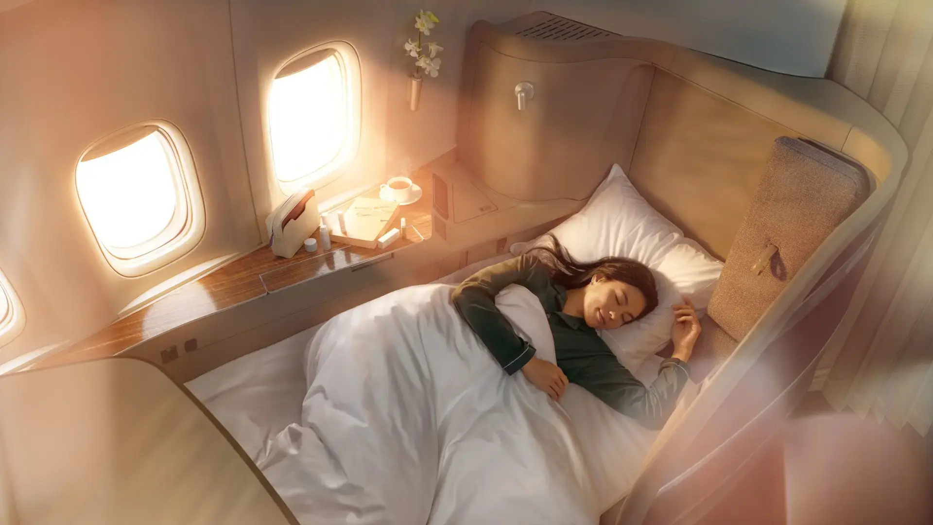 a woman sleeping in the bed of cathay pacific first class