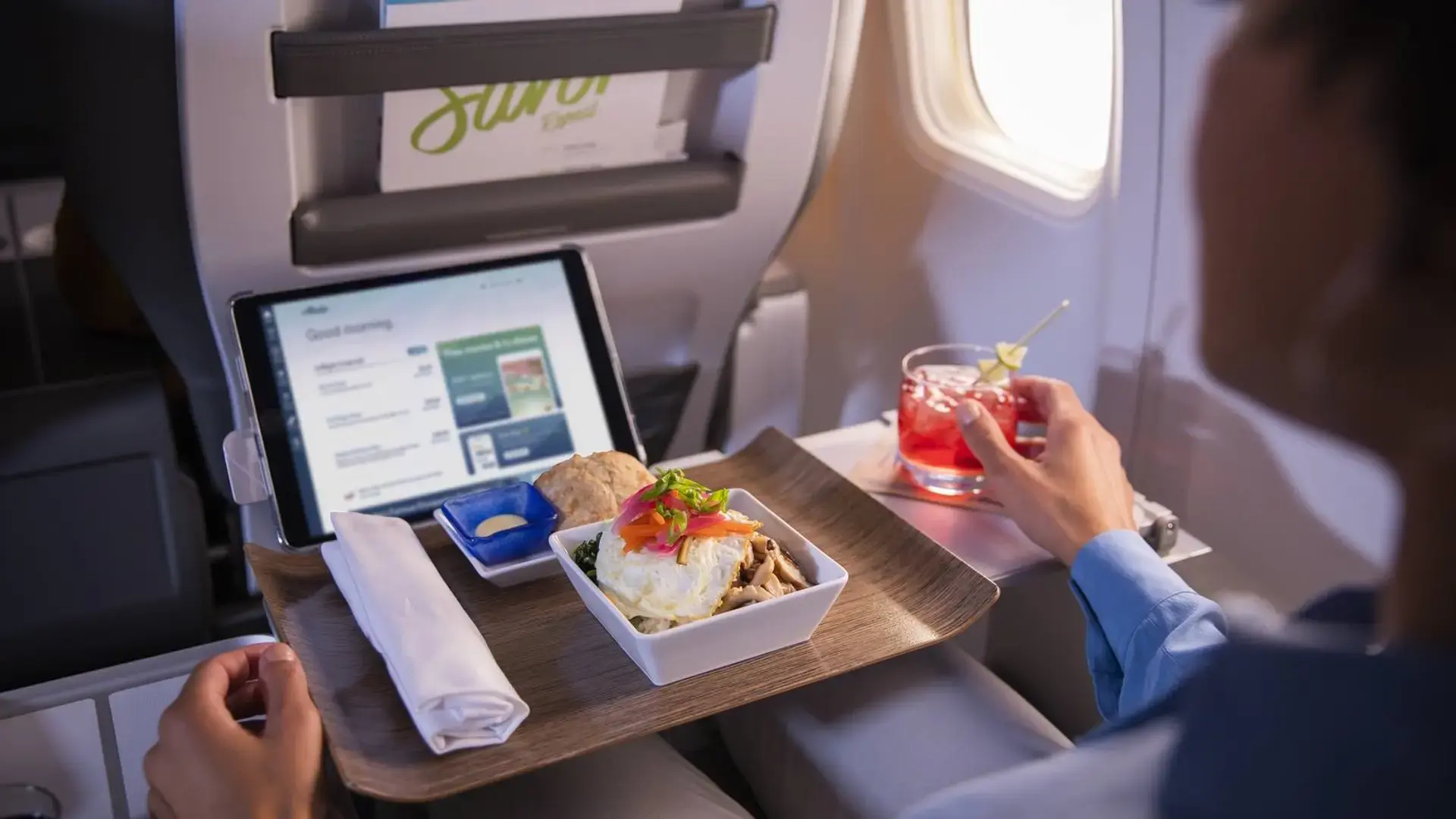 a man having lunch in alaska airlines first class