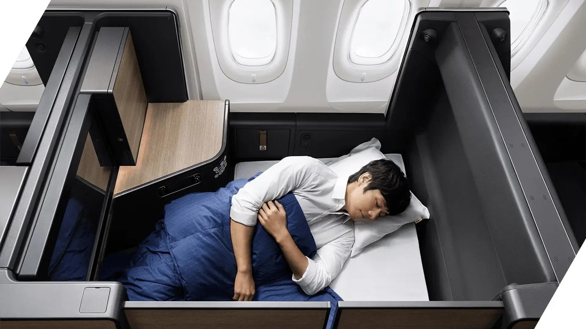 a man sleeping in his ana the room's business class seat