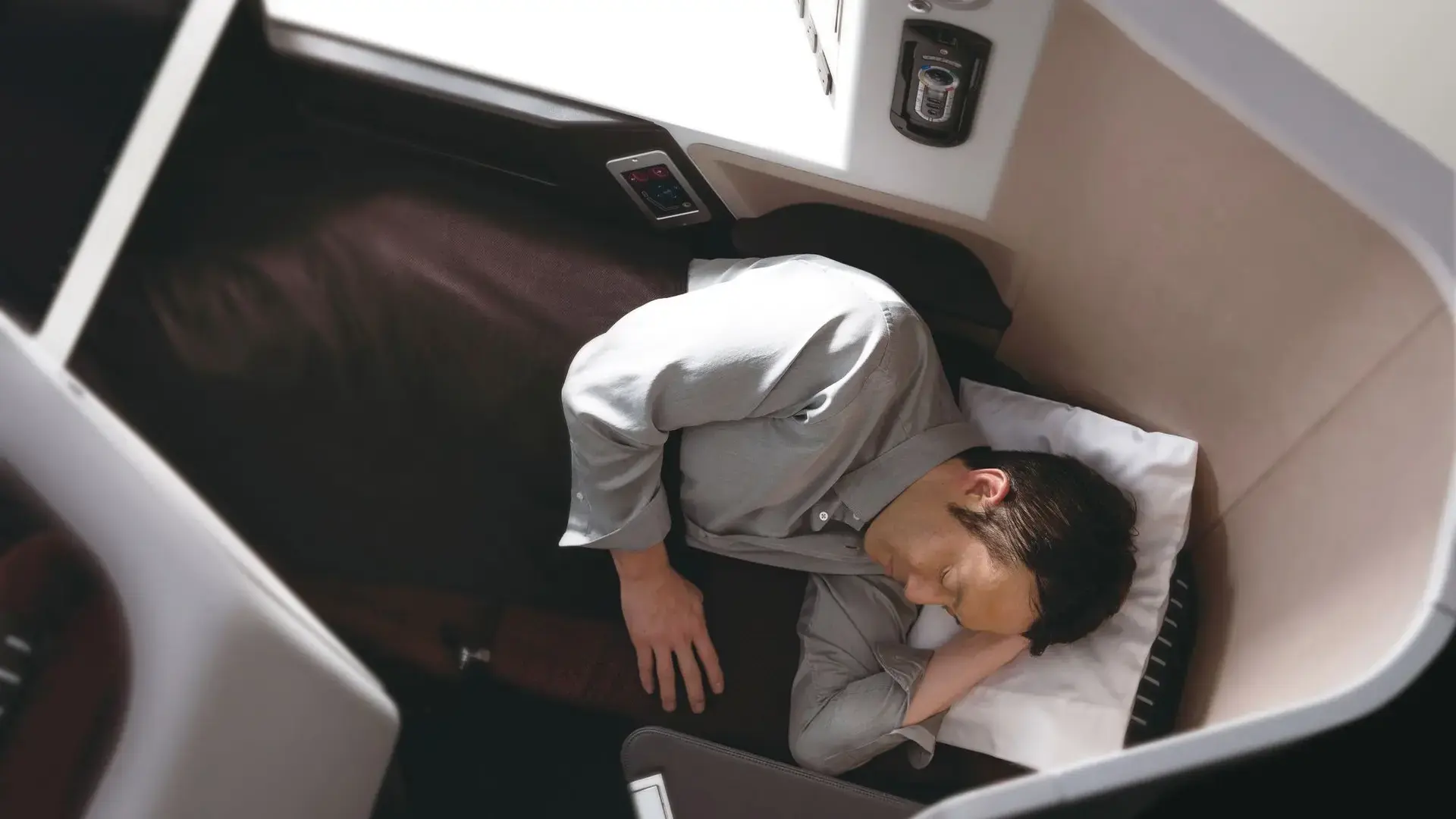 a man sleeping in Japan Airlines – JAL SKY SUITE 