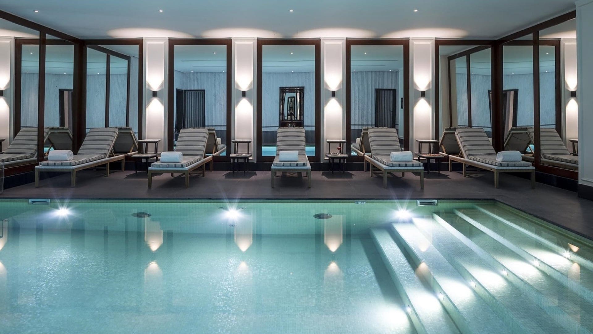 Indoor swimming pool area and spa with sunbeds