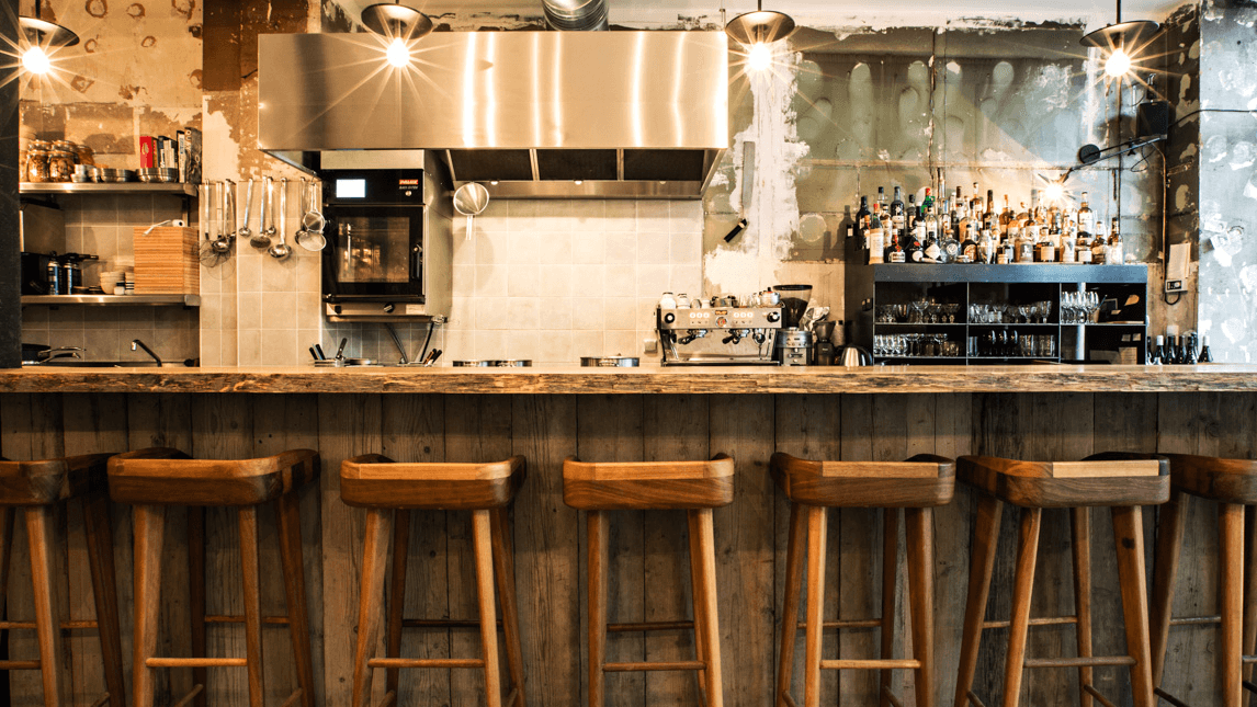 Inside Dersou a wooden bar, with white walls, and cocktails.