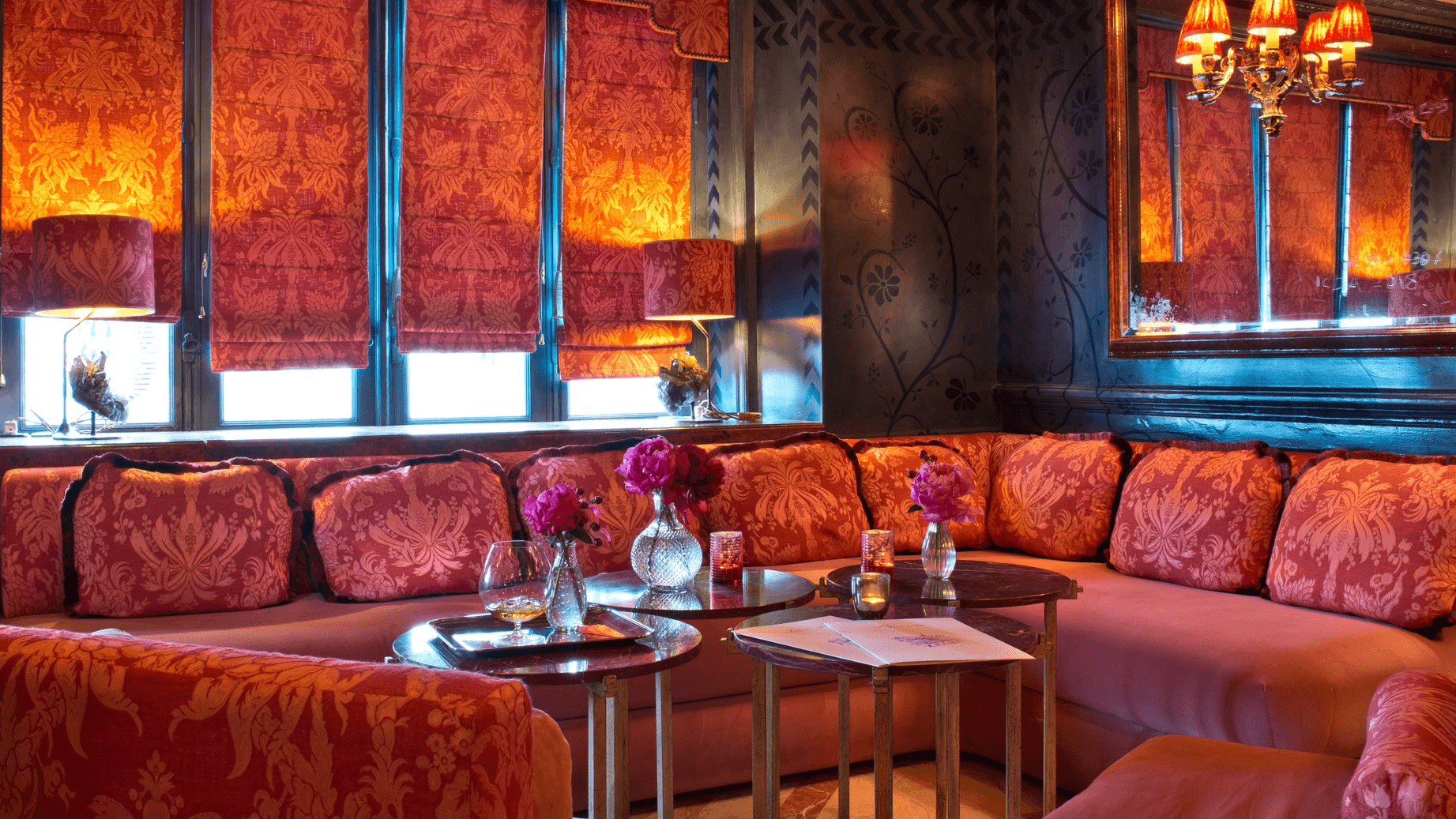 Inside Laperouse bar, red sofas, red rouses and windows and red decor.
