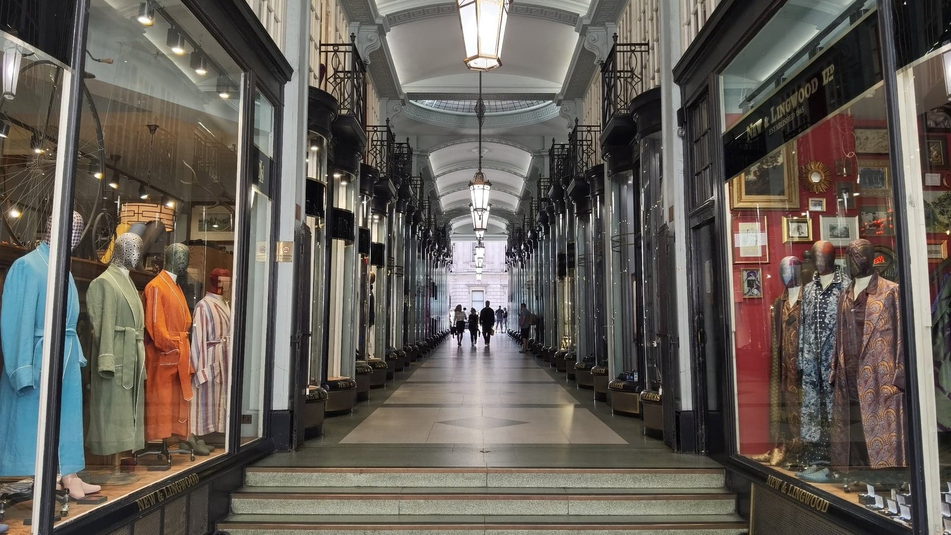a view of Jermyn Street with shops on both sides and people walking down the middle