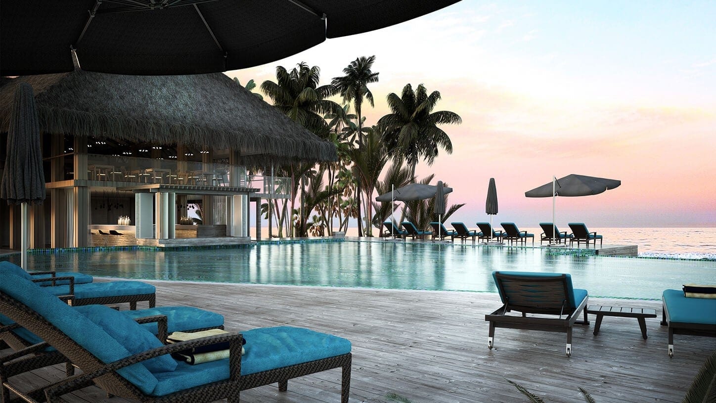 Pool and sunbeds next to the ocean at Baglioni Resort Maldives.