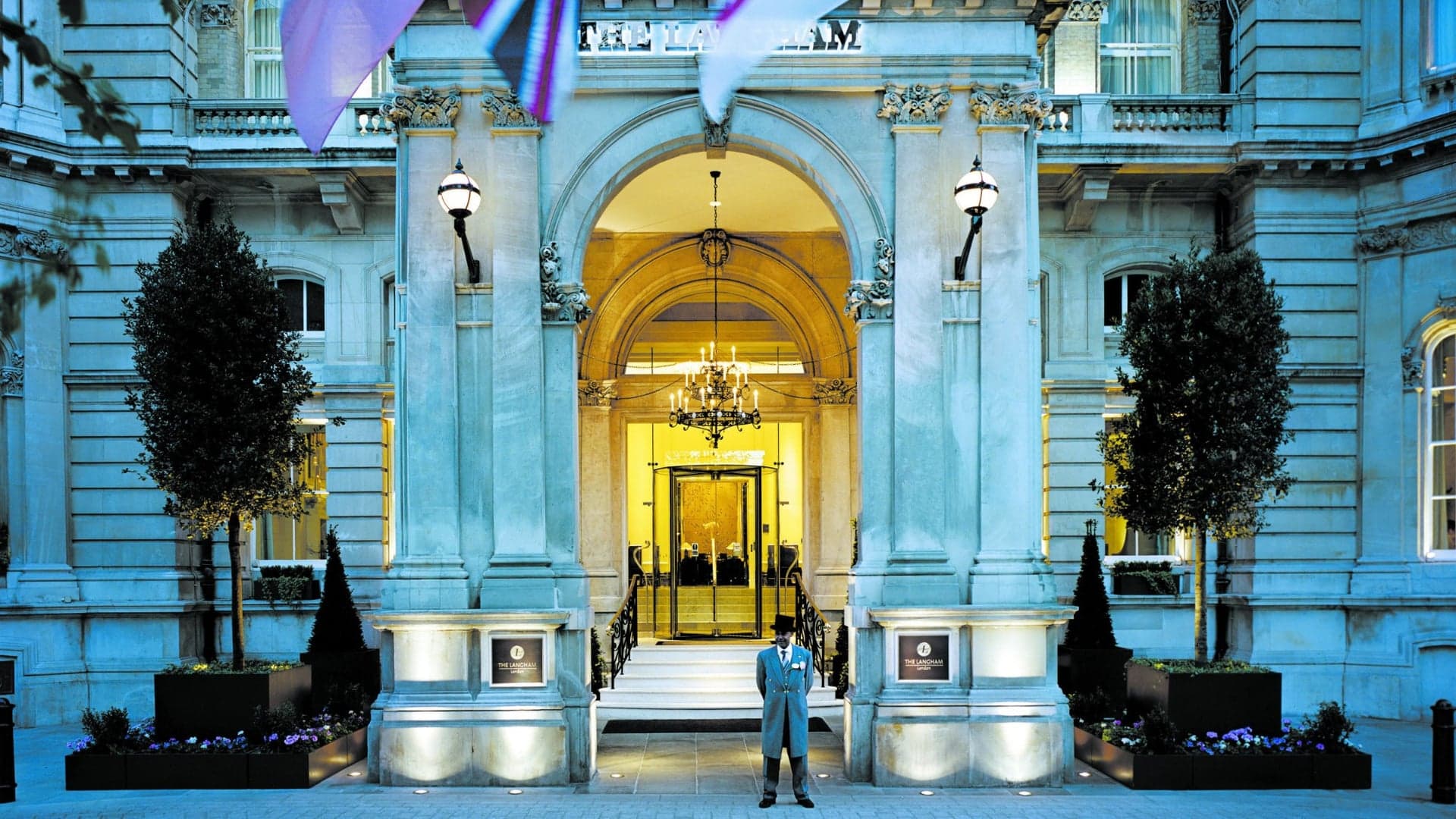 Front entrance of the langham london with a doorman infront