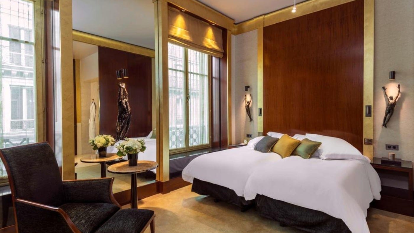 room at park hyatt paris-Vendome with a king sized bed and gold decor around