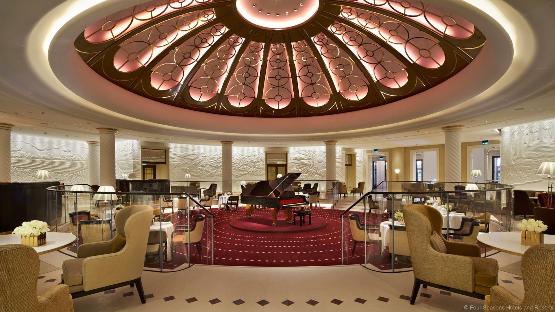 Resturant at the four seasons hotel london at ten trinity square with a black piano in the center.