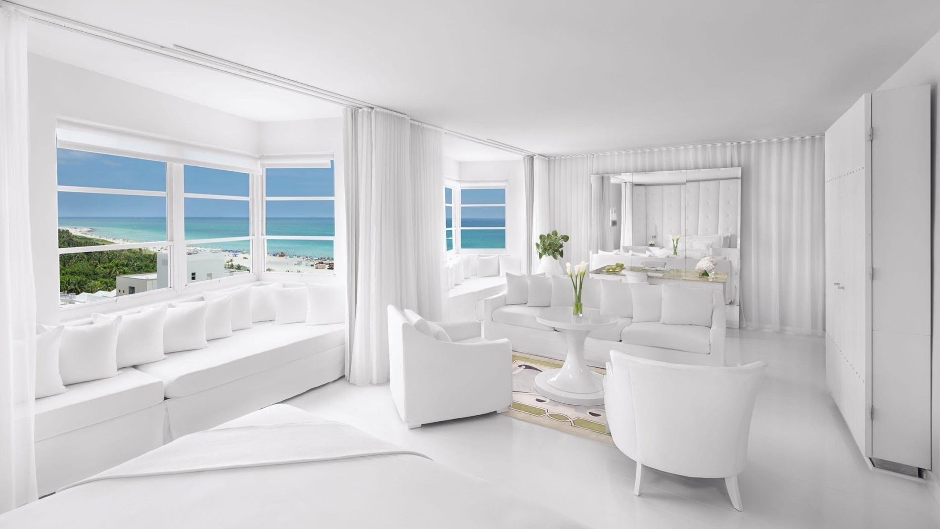 The all-white exclusive room with view of the beach