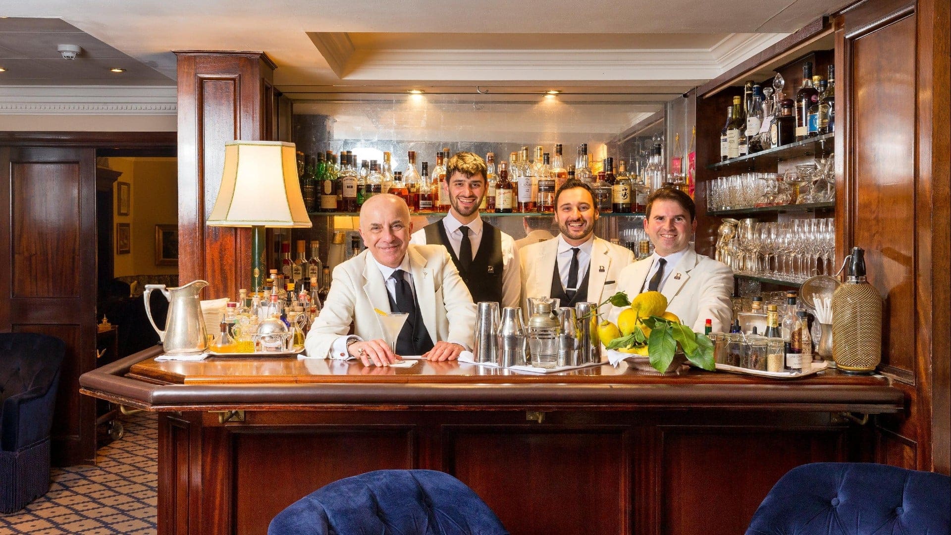Duke's Bar - St James's staff smiling while standing at the bar