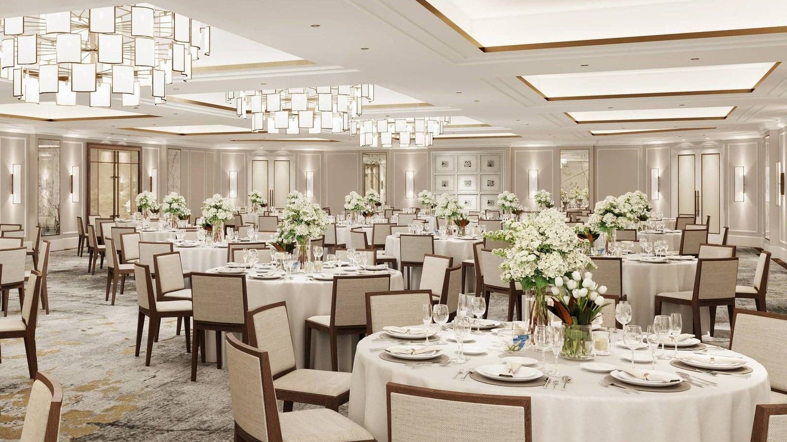 The The Chinoiserie resturant at the carlton tower Jumeirah with a white finish and flowers on each table.