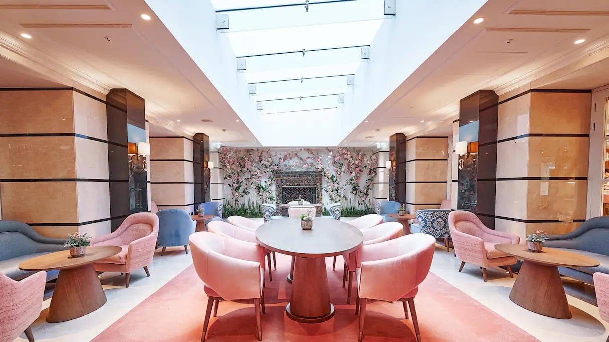 Art deco pem resturant with pink chairs and a pink carpet at Conrad London st james