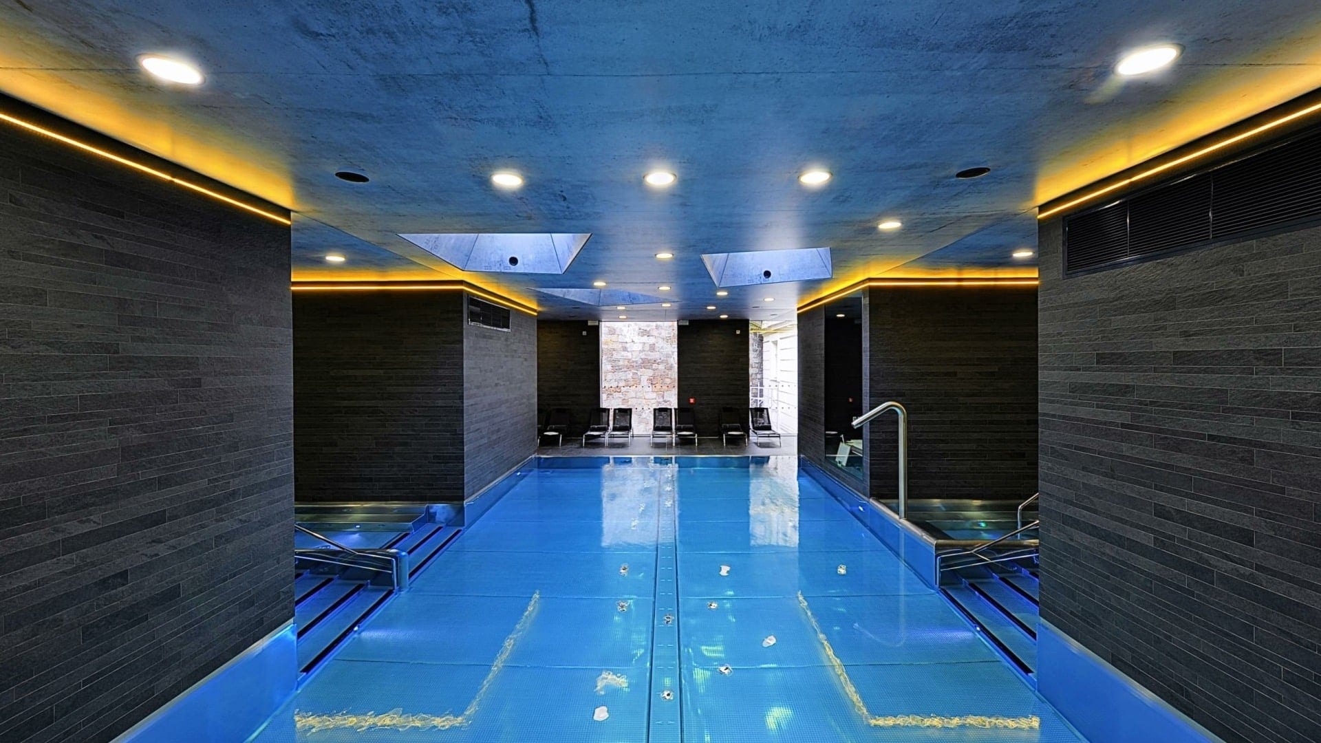 Bathing and spa area at Grandhotel pupp with black, modern design and sunbeds