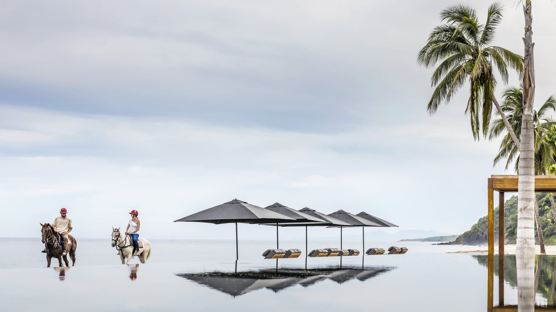 a couple horse riding at One&Only Mandarina, Mexico