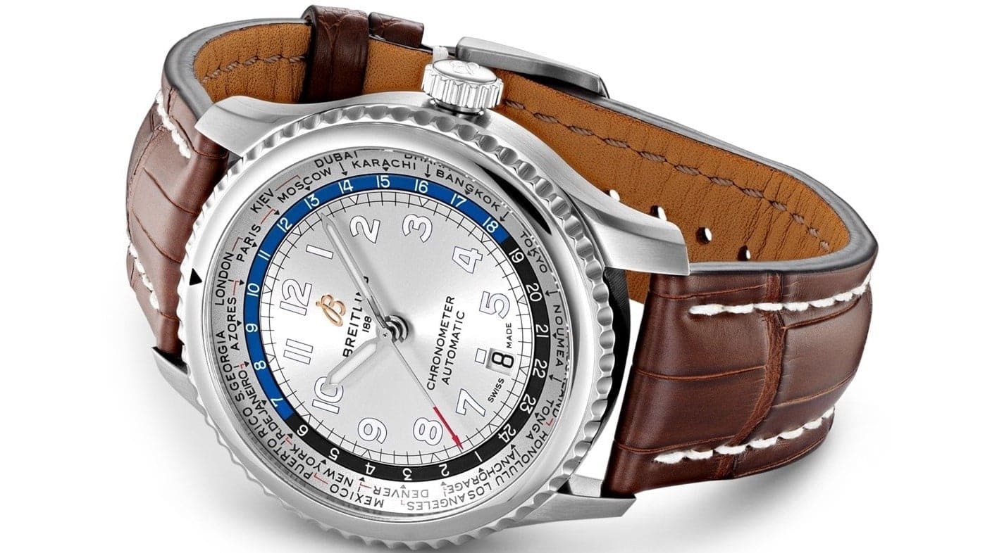 A Breitling Aviator travel watch with brown strap and a metal case.