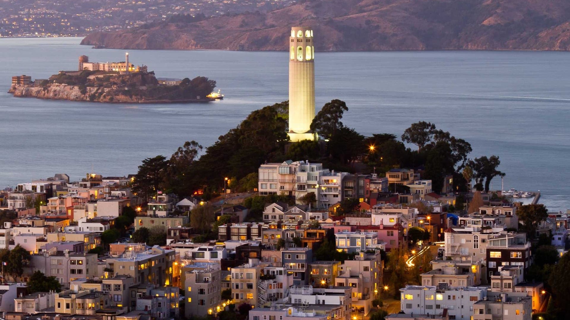 View of Coit Tower on top of Telegraph Hill with a 64 meter height and lighting up San Francisco.