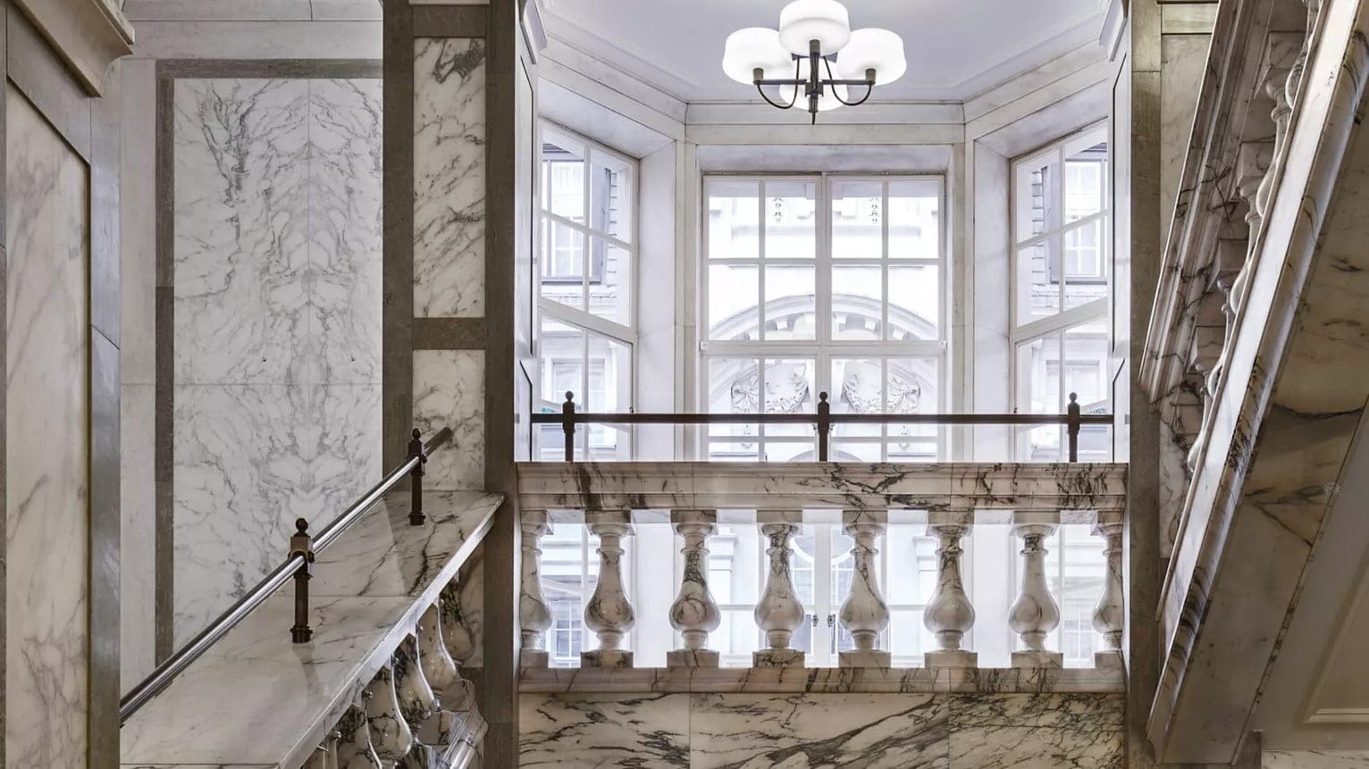 A staircase made of white marble at rosewood london.