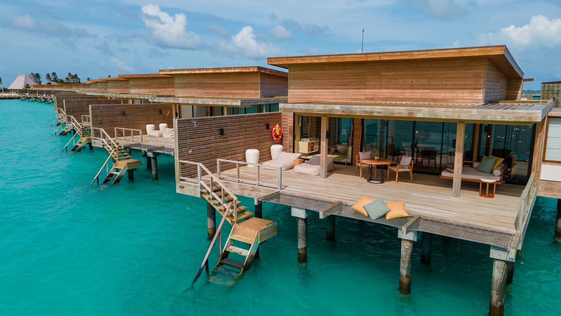 Wooden suites on the water with staircase to water at Kudaa Villingili