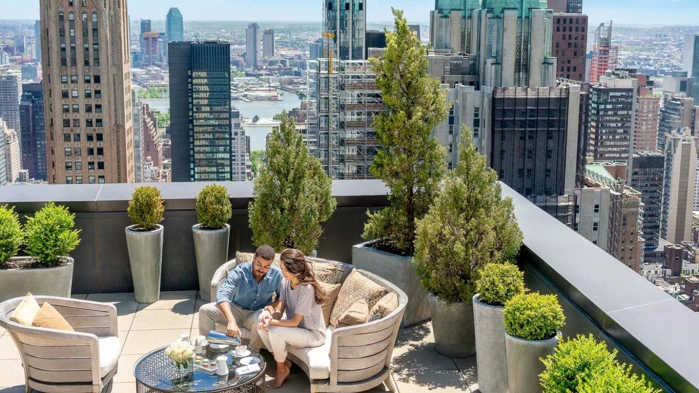 a couple enjoying a meal at a terrace at lotte new york palace