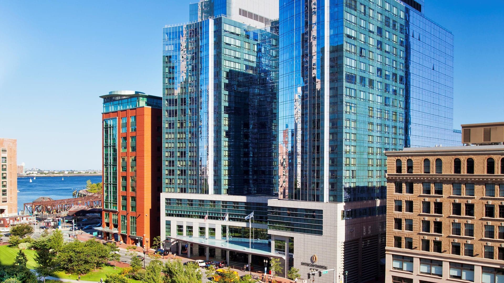 A modern hotel made by glass with two symetrical glass collumns.