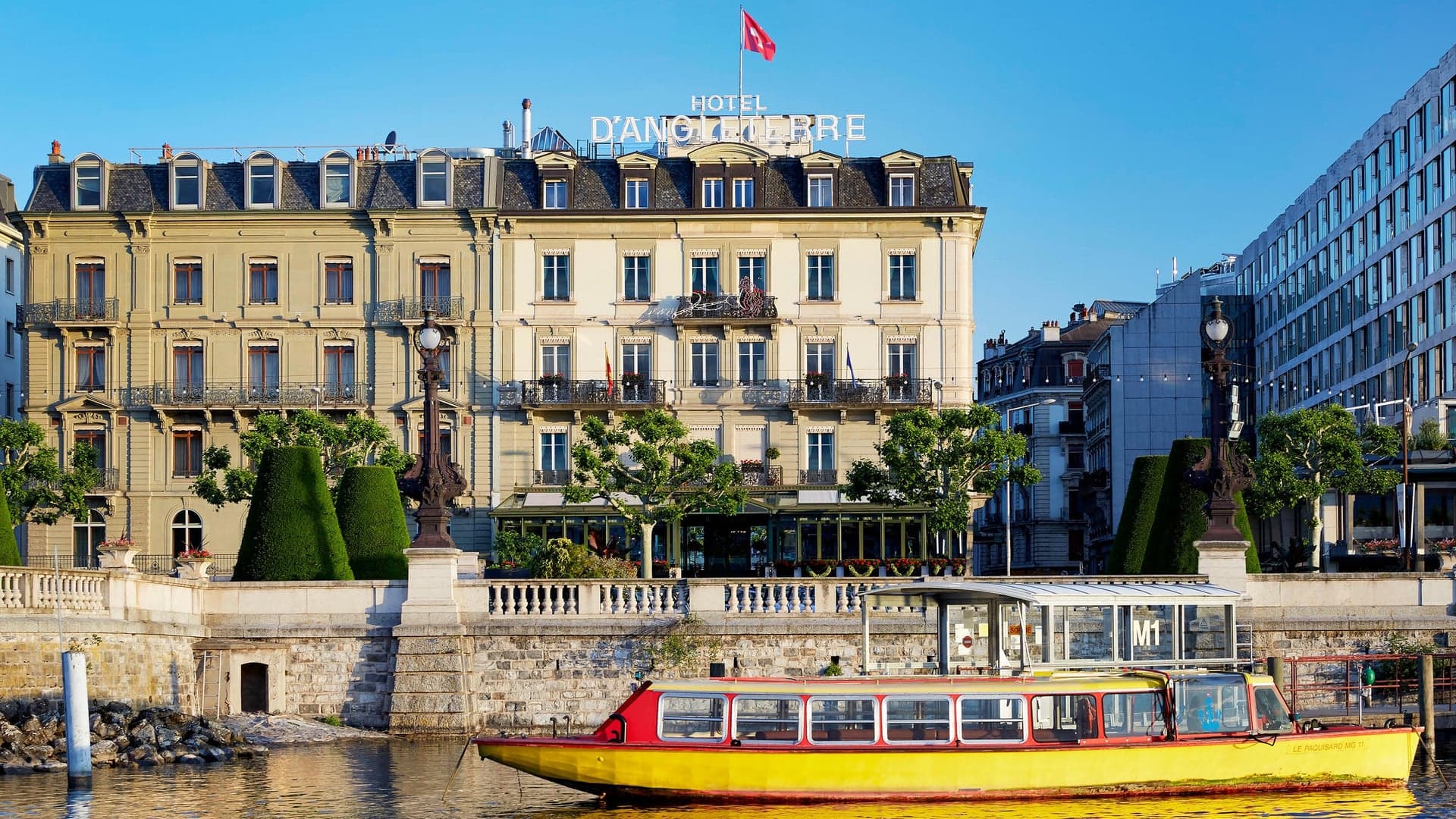 River view of The Hotel d'Angleterre with a yellow boat