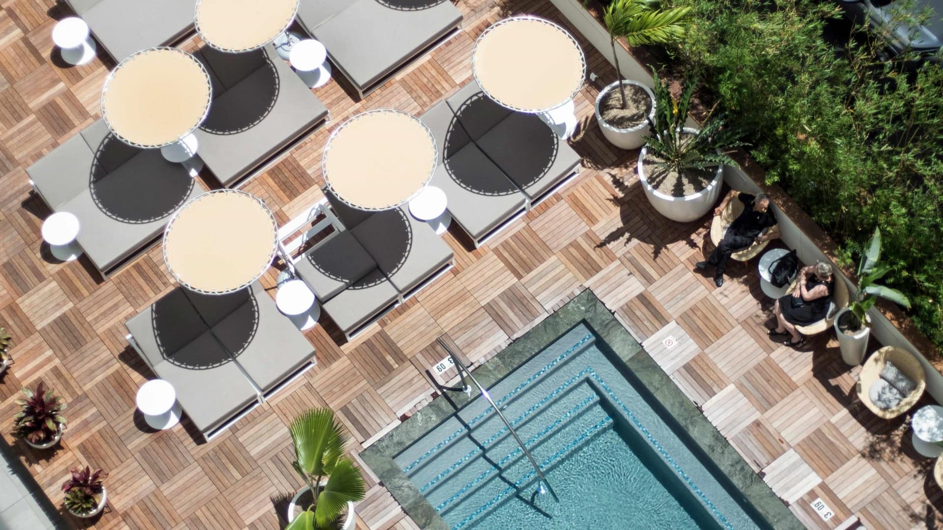 Bird view of pool and sunbeds at The Laylow Autograph Collection.
