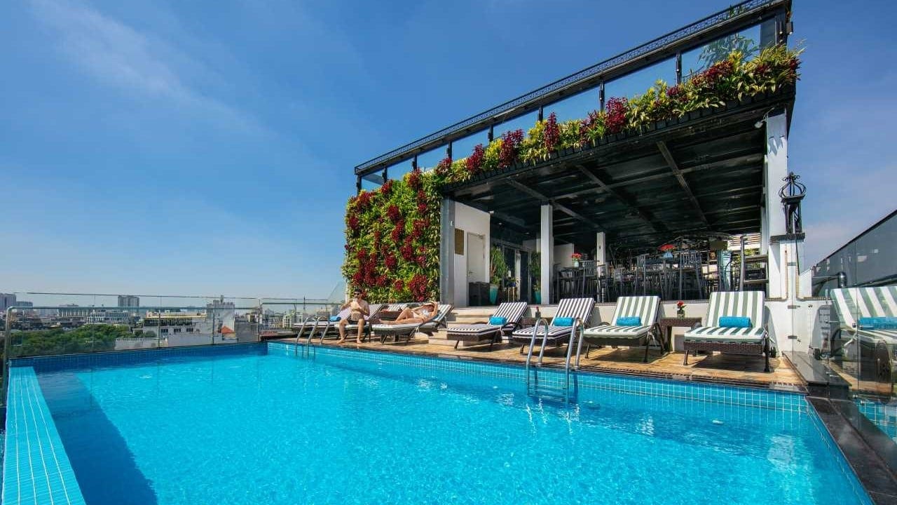 a couple relaxing at The Oriental Jade Hotel's swimming pool