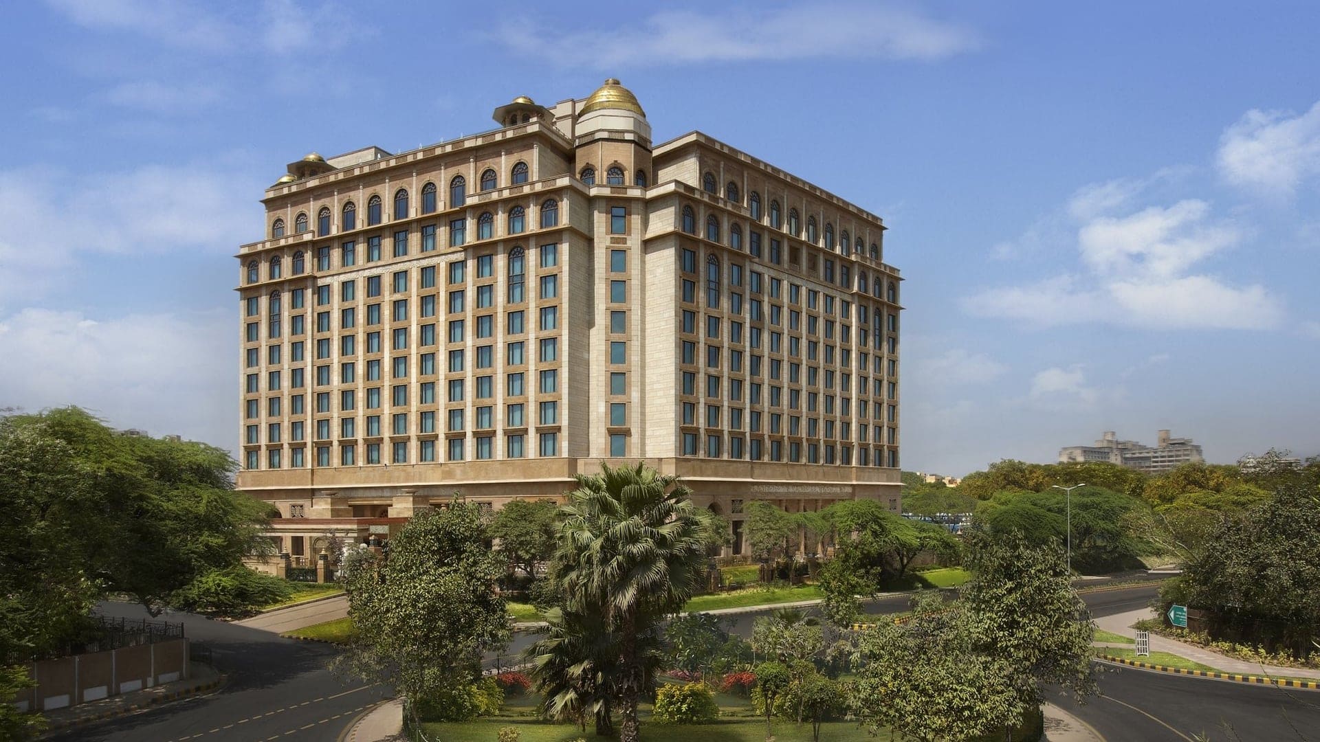 Outside view of the large Leela Palace New Delhi with nature surrounding it