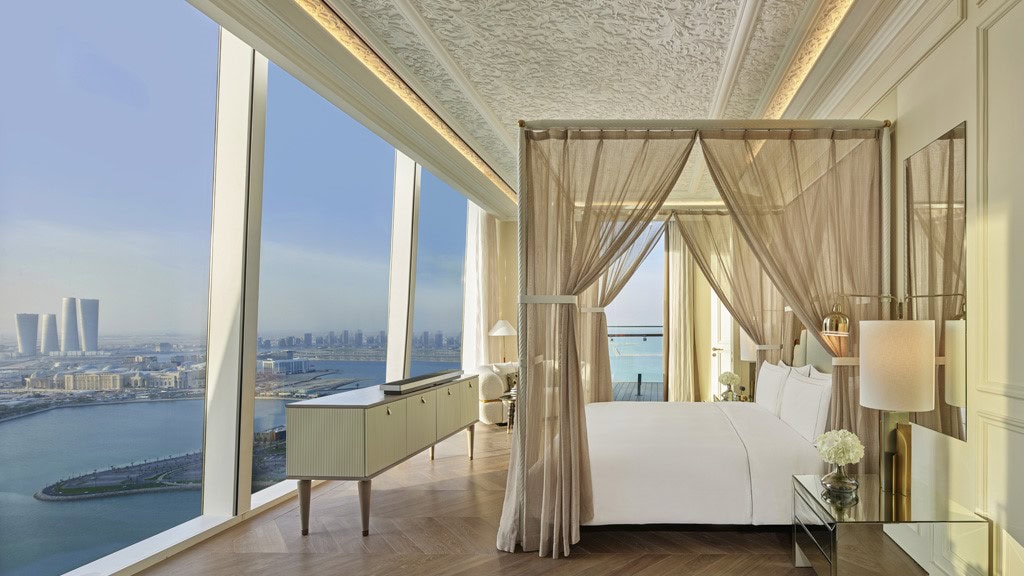 a room at Raffles Doha overlooking the river and city through its large windows