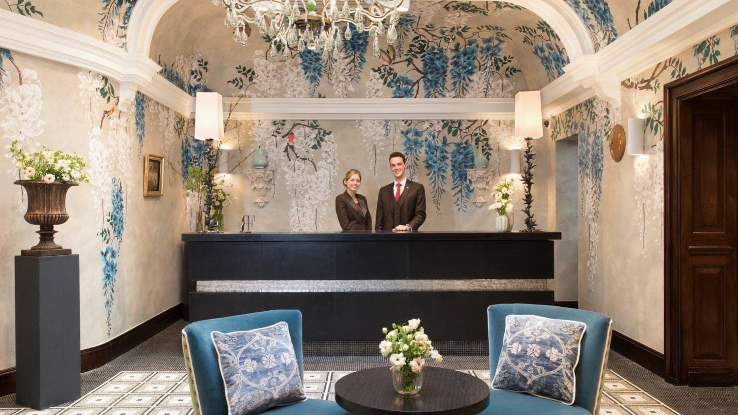 Reception of Brown´s hotel with two hotel wokers behind the counter