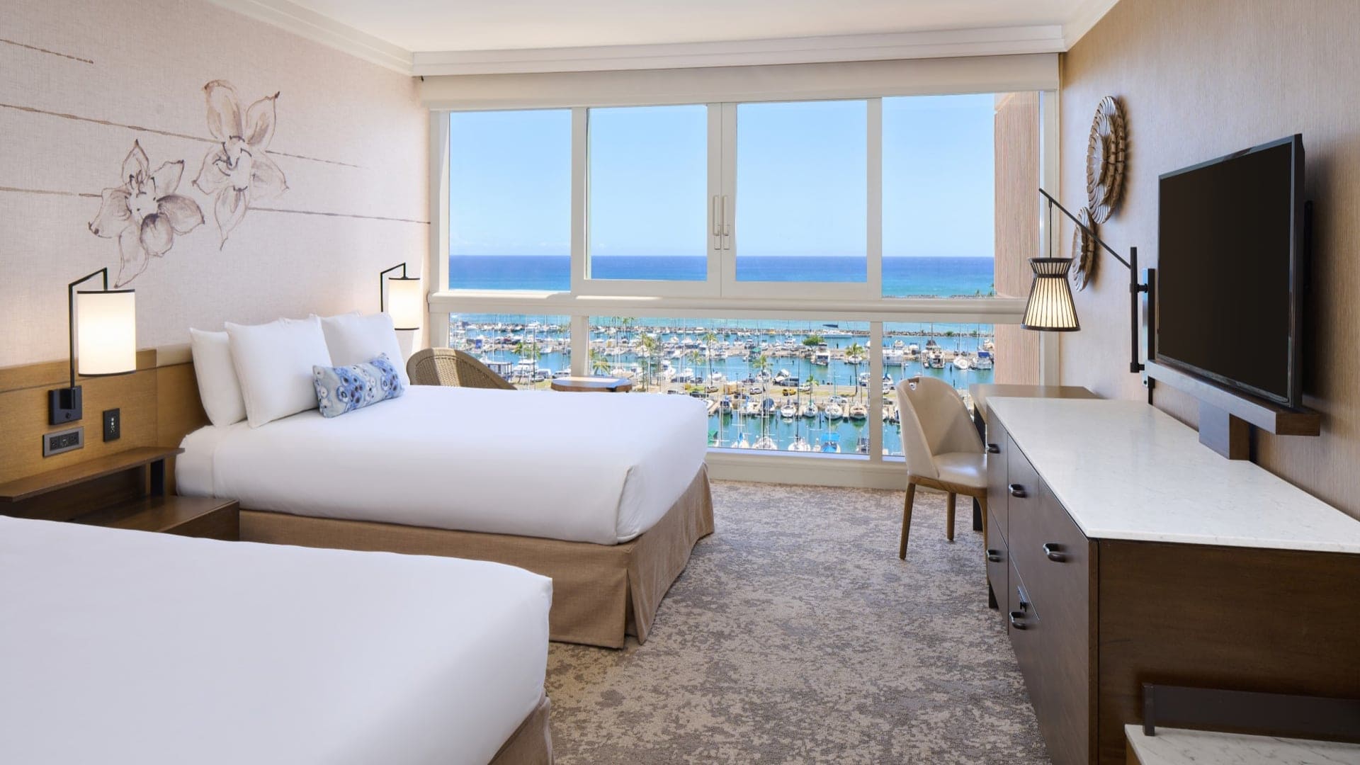 Hotel room with two single beds, flatscreen tv and view to the shore at Prince Waikiki.