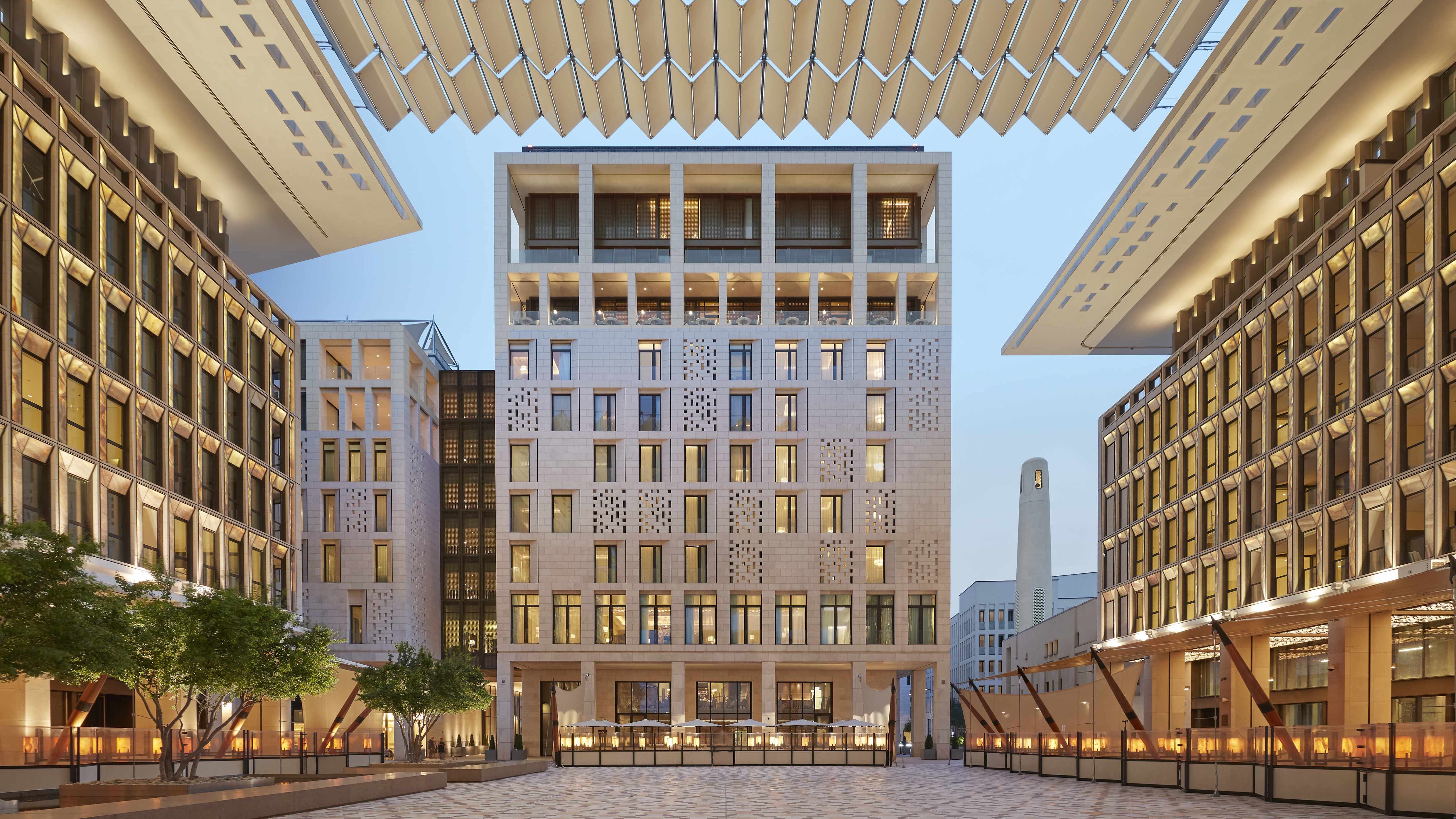 Outside view of The Mandarin Oriental Doha hotel, Large pathway in with a beautiful large buildning. 